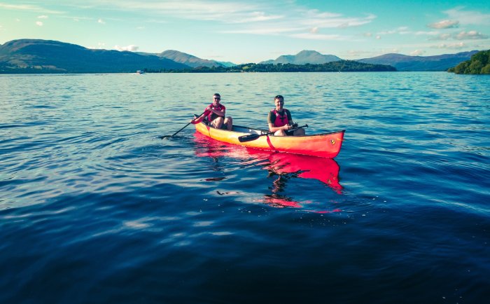 Men kayaking on lake in United Kingdom